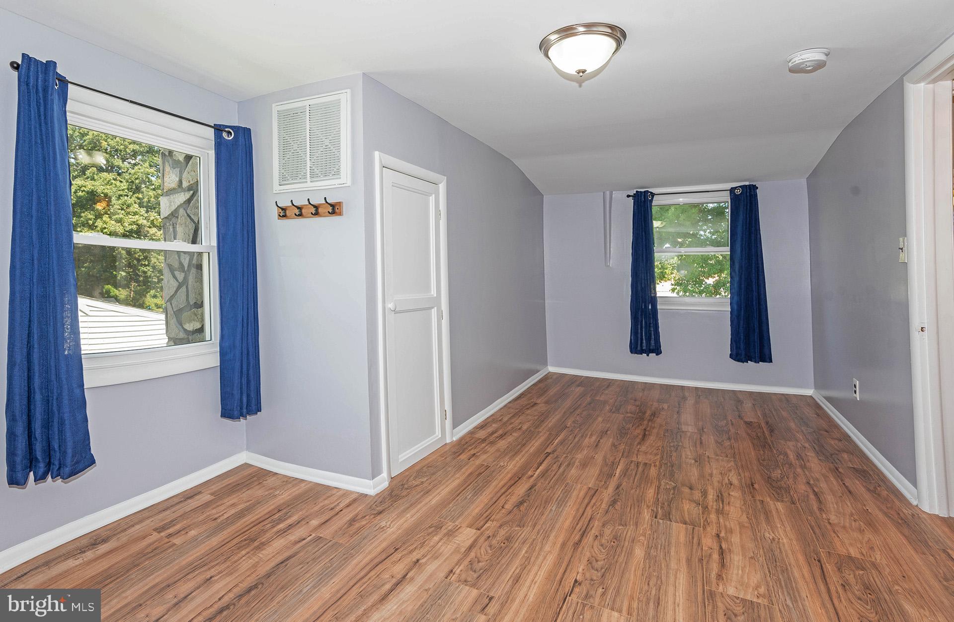 4506 Morgan Road Morningside, MD 20746 - Photo 14 of 22 a view of an empty room with wooden floor and a window