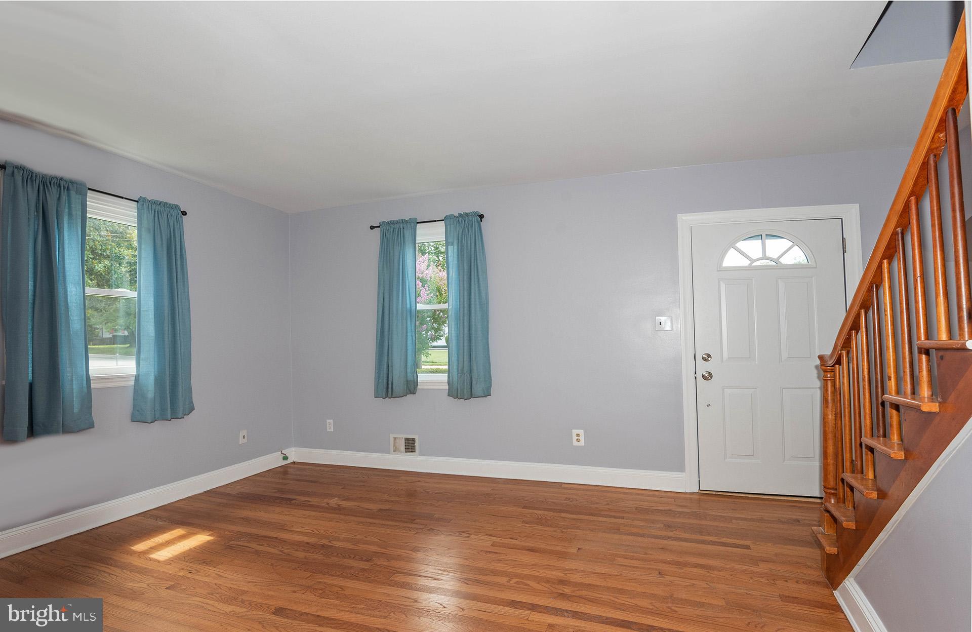 4506 Morgan Road Morningside, MD 20746 - Photo 3 of 22 a view of an empty room with wooden floor and a window