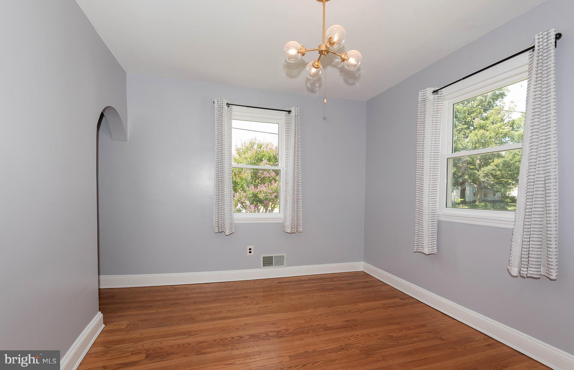 4506 Morgan Road Morningside, MD 20746 - Photo 5 of 22 a view of an empty room with wooden floor and a window