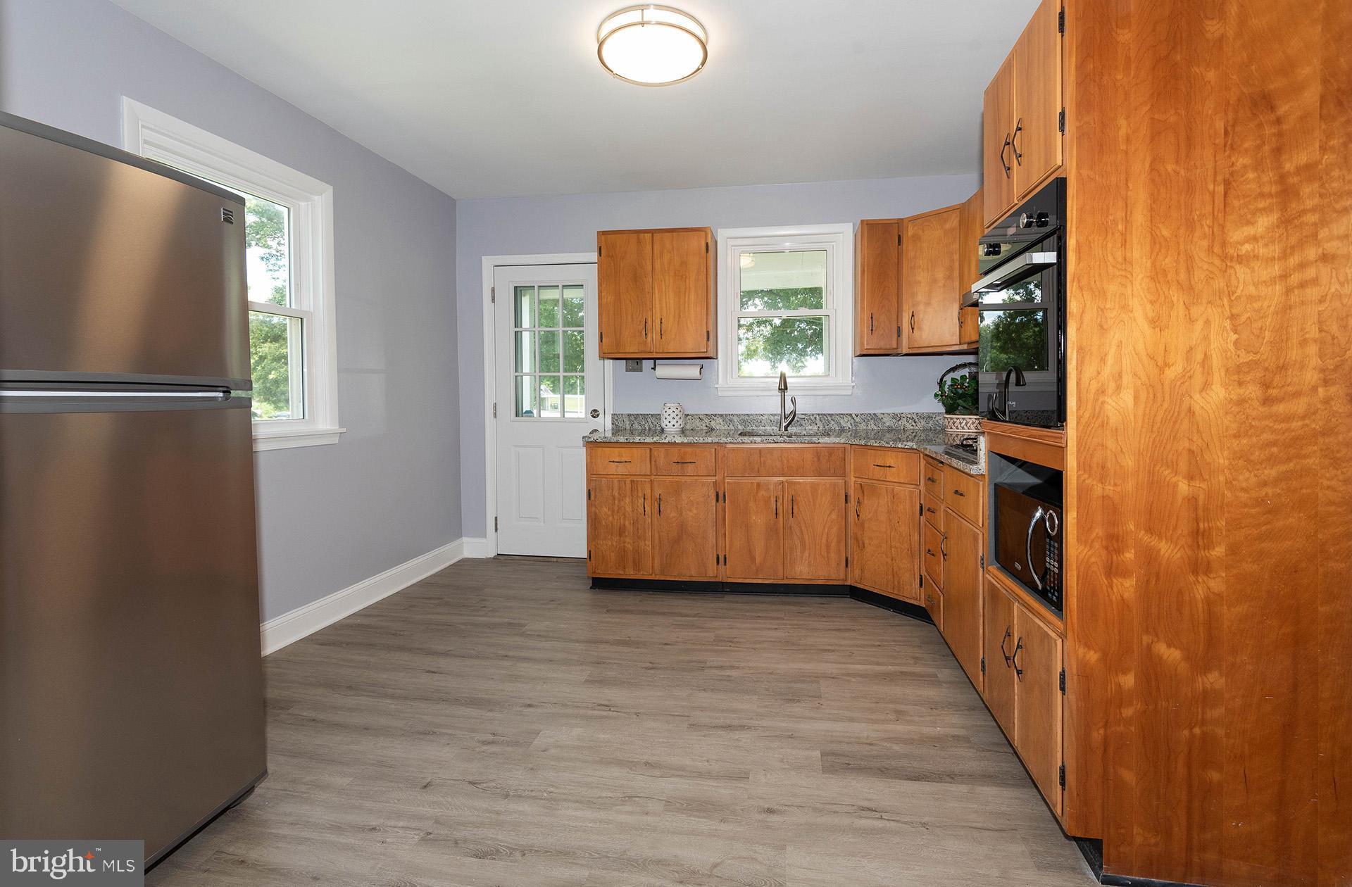 4506 Morgan Road Morningside, MD 20746 - Photo 6 of 22 a kitchen with stainless steel appliances a sink and a refrigerator