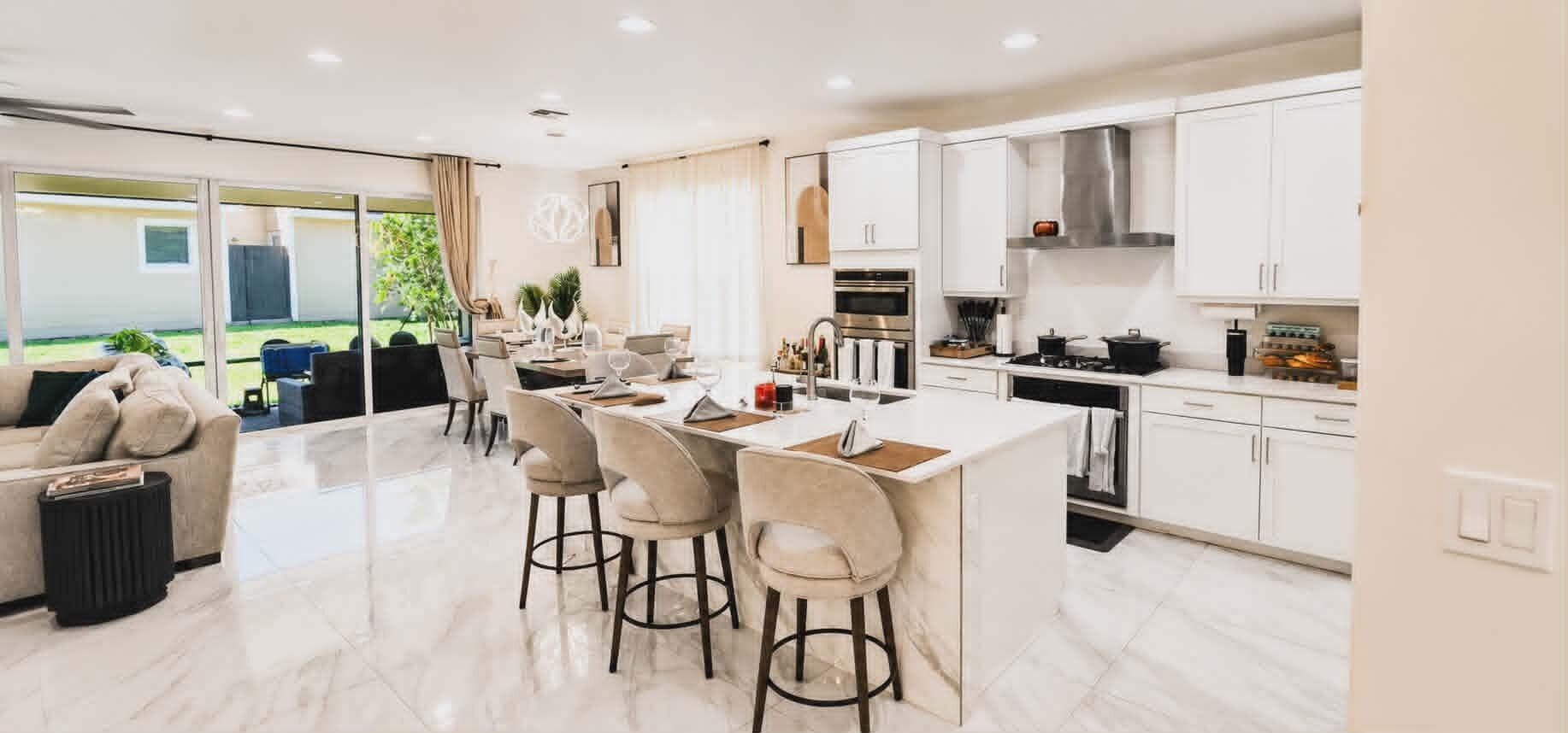 19179 Rolling Acrs Road Loxahatchee, FL 33470 - Photo 12 of 38 a kitchen with stainless steel appliances a sink a stove a refrigerator cabinets and dining table