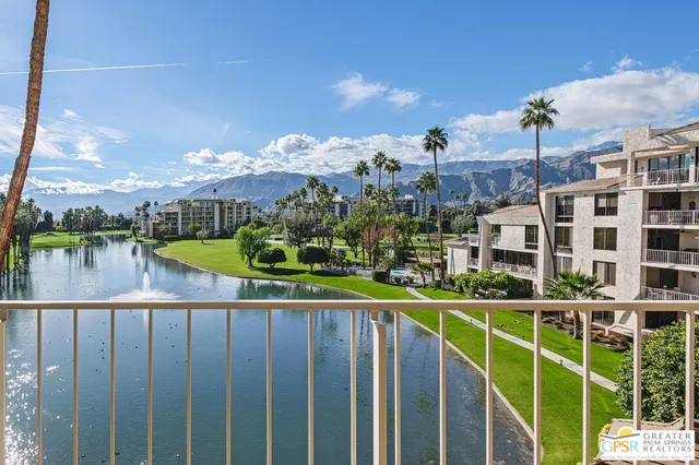 a view of a balcony with wooden floor and lake view