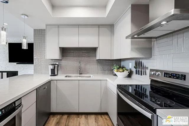 a kitchen with a refrigerator and a stove top oven