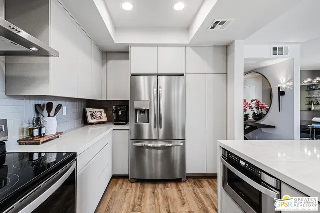 a bedroom with furniture and large windows