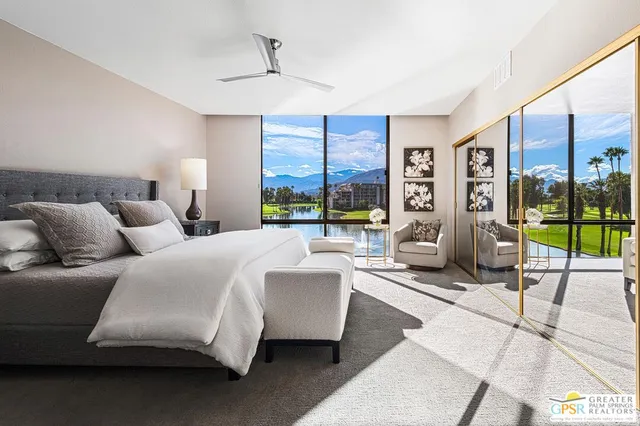 a bedroom with a bed and mirror