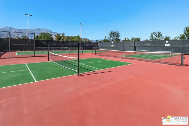 a view of a city with lots of residential buildings ocean and mountain view in back