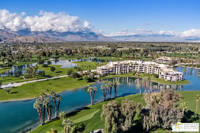 a view of a lake with houses in the back