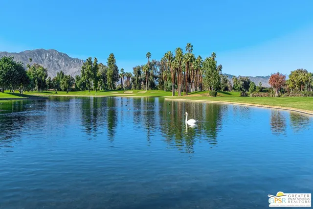 a backyard of a house with lots of green space and outdoor seating
