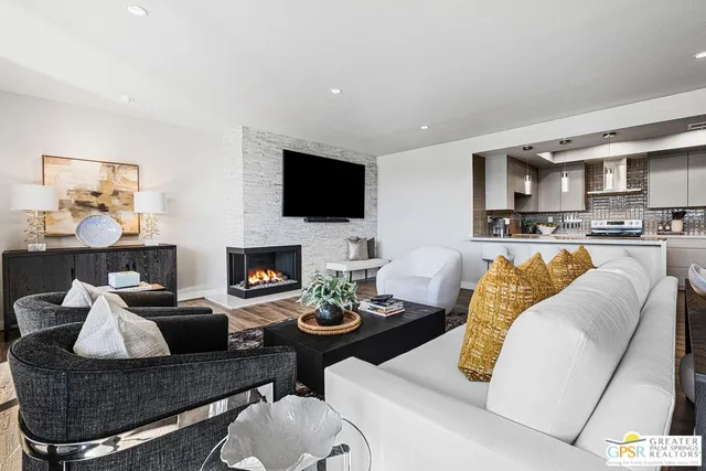 a living room with furniture fireplace and a flat screen tv