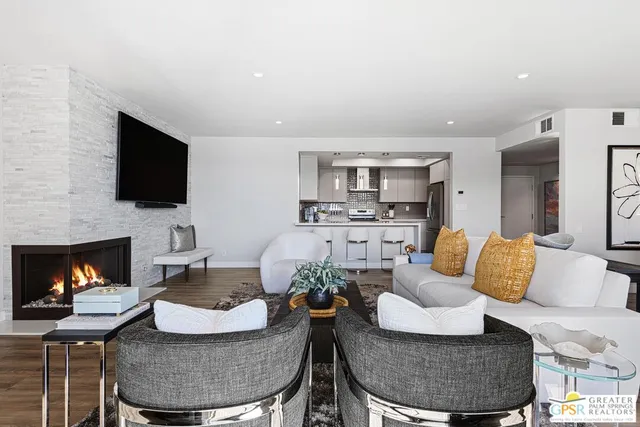 a living room with furniture and a fireplace
