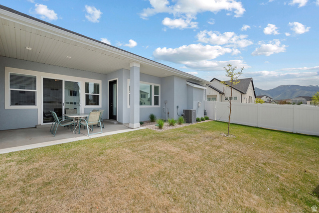 531 North Legend Way West, Unit D Mapleton, UT 84664 - Photo 27 of 42 Fenced yard with a patio and a mountain view