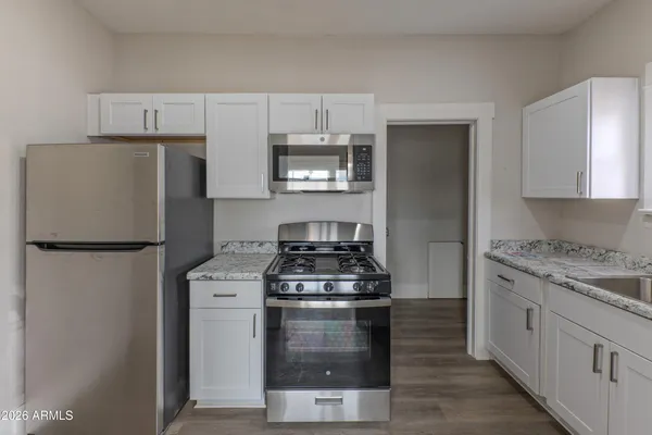a kitchen with a stove and a refrigerator