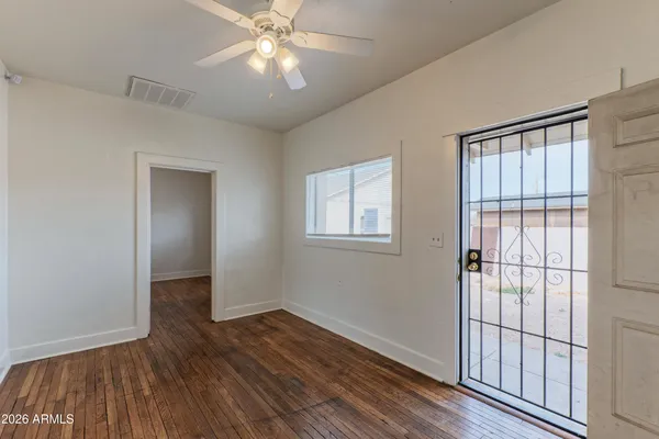 wooden floor in an empty room with a window