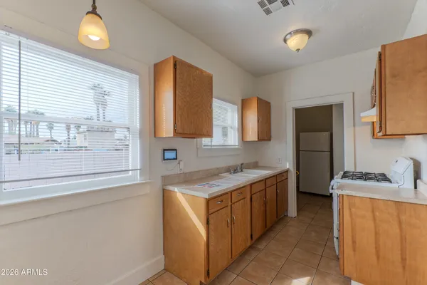 a kitchen with a sink stove and cabinets