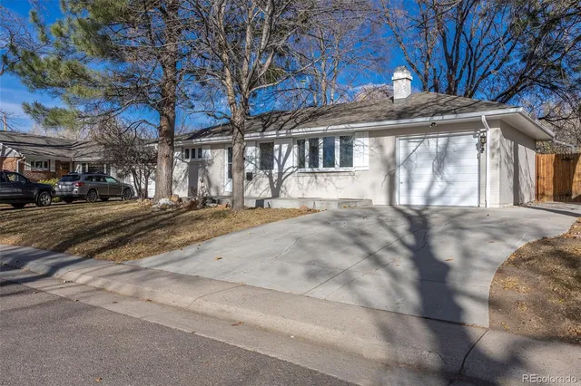 a front view of a building with a garden