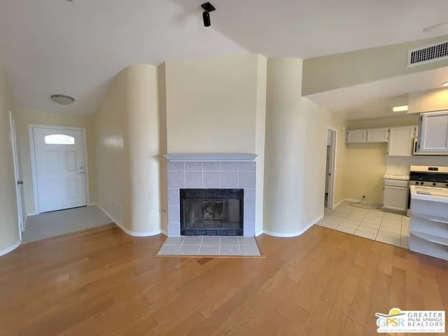 a kitchen with stainless steel appliances kitchen island granite countertop a refrigerator a stove a sink and a large window