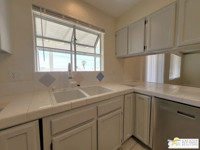 a kitchen with stainless steel appliances a stove microwave and sink