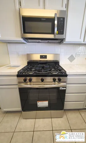 a kitchen with a sink cabinets and window