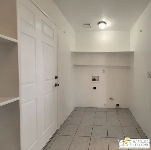 an empty room with windows and ceiling fan