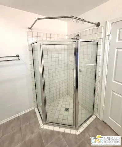 an empty room with closet and a ceiling fan