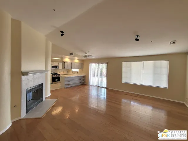 a view of kitchen and hall with wooden floor