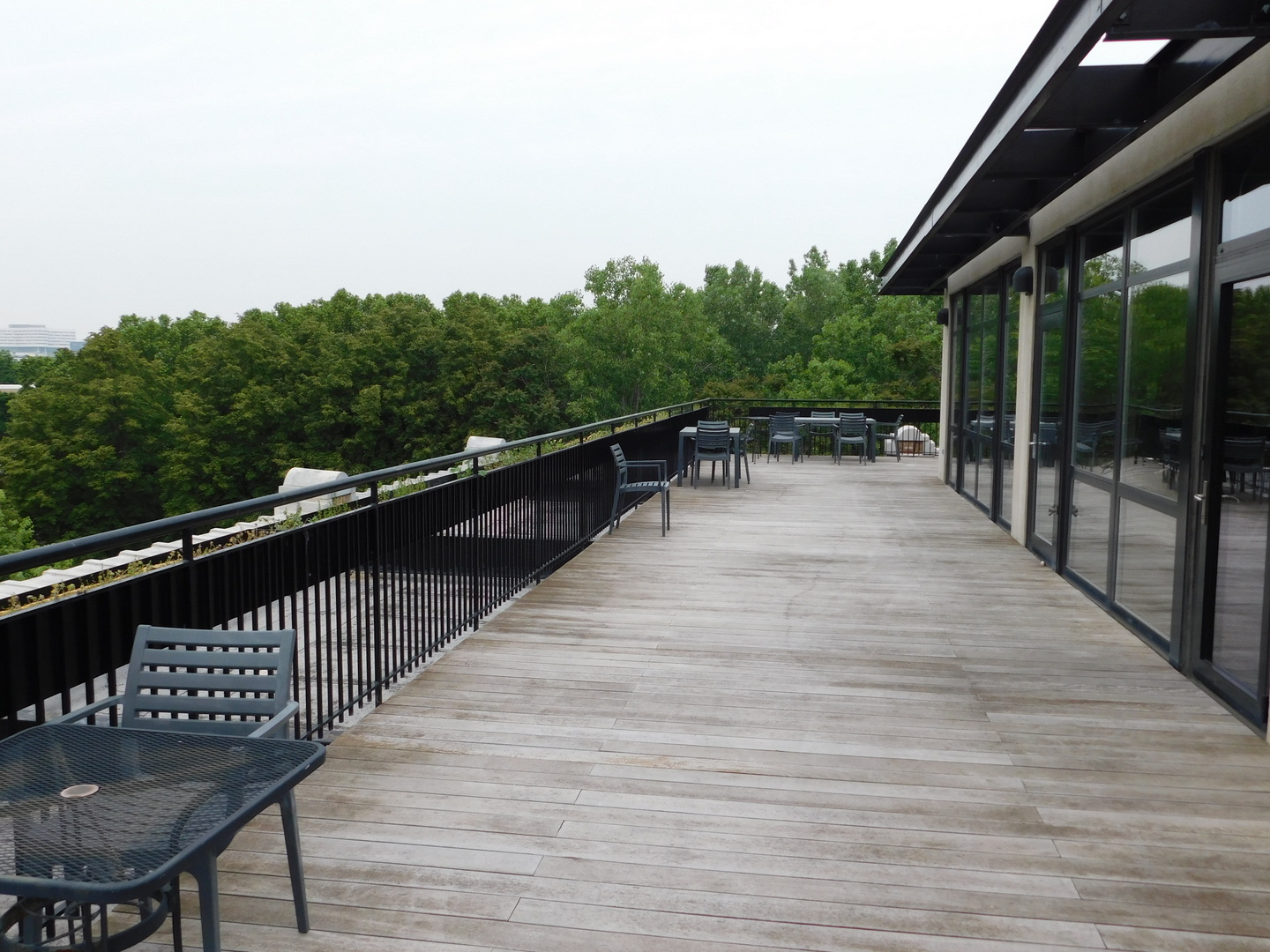 1069 West 14th Place, Unit 204 Chicago, IL 60608 - Photo 16 of 18 a balcony with wooden floor and outdoor seating