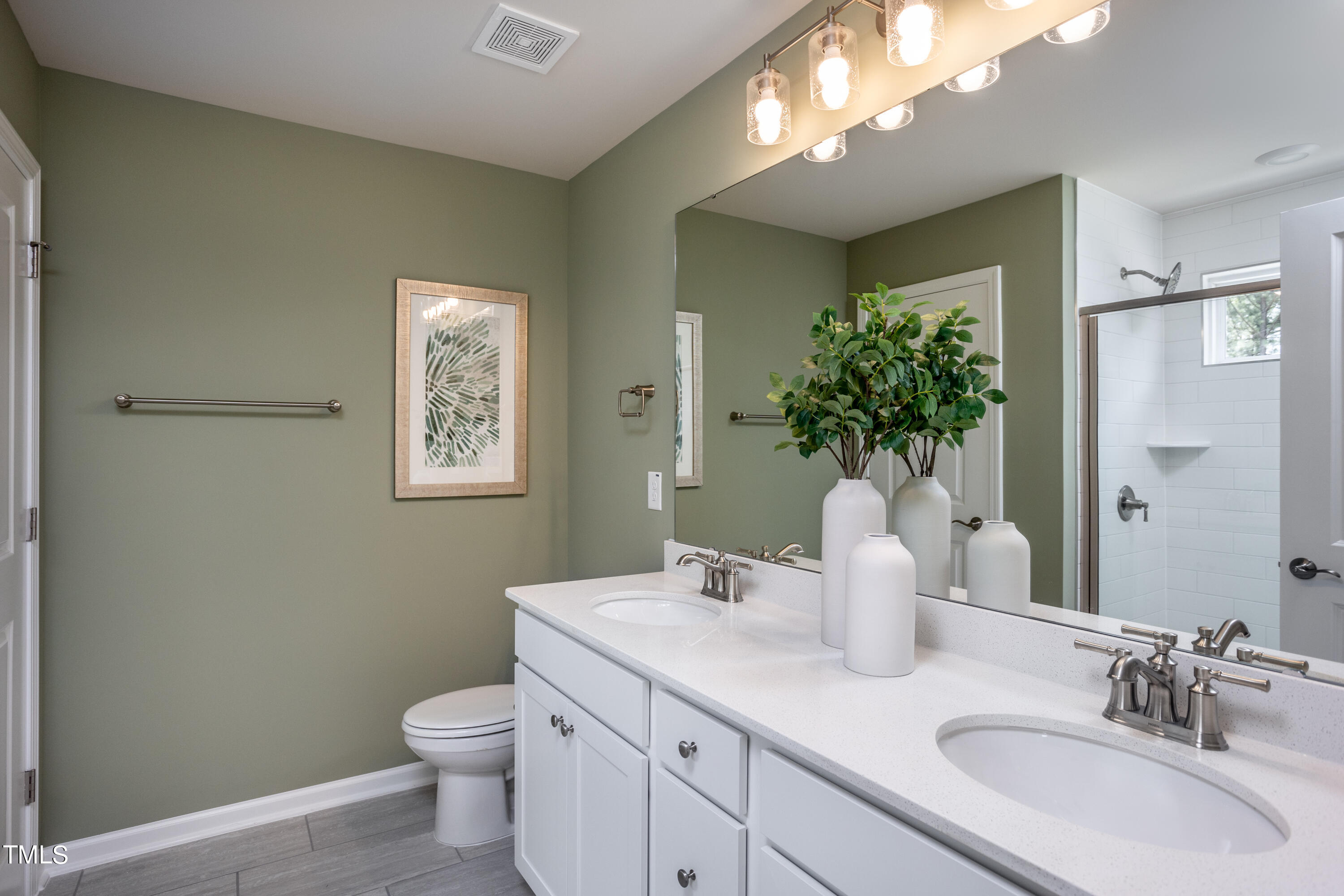 175 Glen Clova Drive Raleigh, NC 27603 - Photo 18 of 26 a bathroom with a toilet sink and mirror
