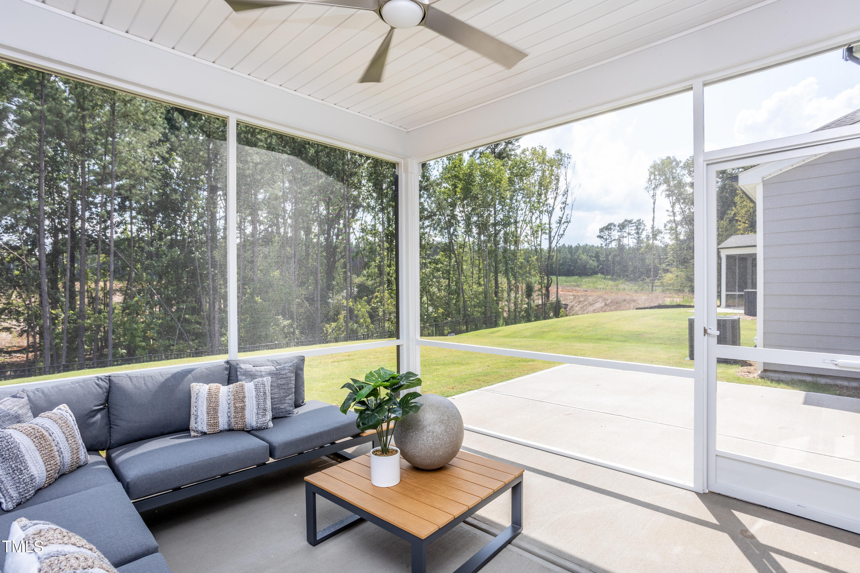 175 Glen Clova Drive Raleigh, NC 27603 - Photo 25 of 26 a living room with furniture and a floor to ceiling window