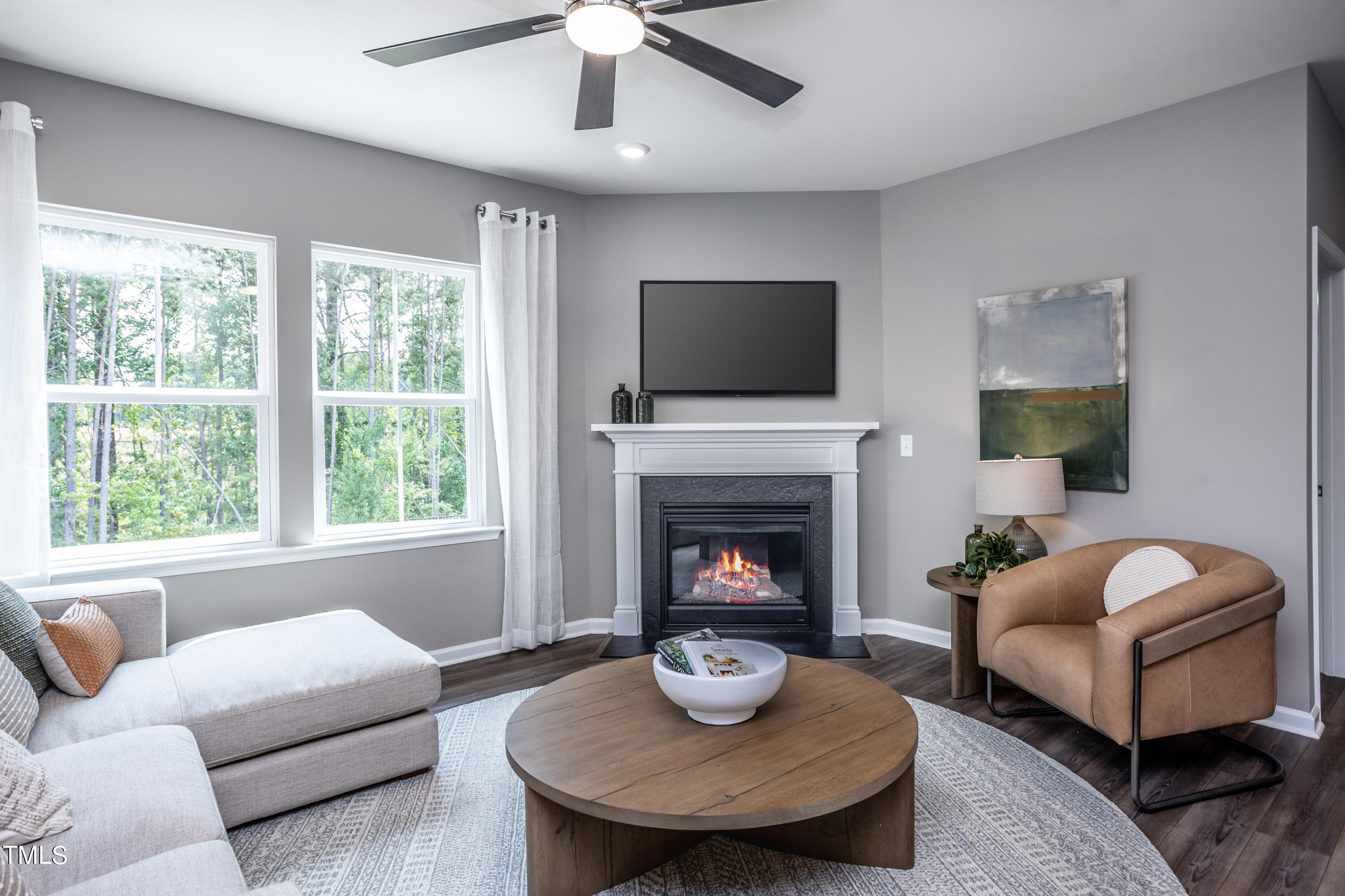 175 Glen Clova Drive Raleigh, NC 27603 - Photo 9 of 26 a living room with furniture a fireplace and a flat screen tv