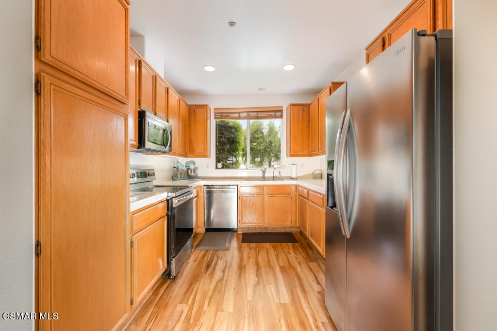 2307 Shakespeare Drive Oxnard, CA 93033 - Photo 13 of 42 a kitchen with a sink refrigerator and cabinets