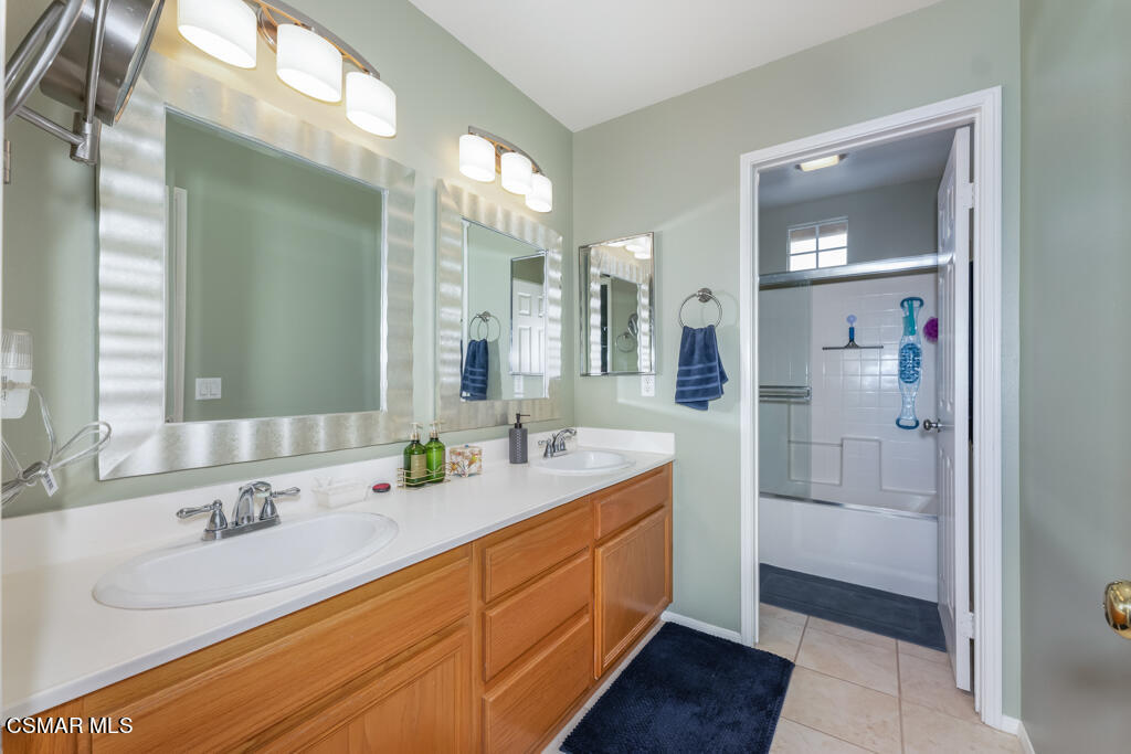 2307 Shakespeare Drive Oxnard, CA 93033 - Photo 24 of 42 a bathroom with a double vanity sink and mirror