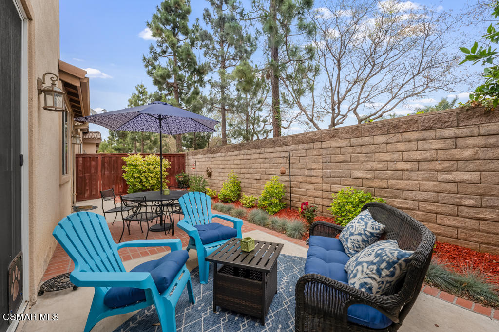 2307 Shakespeare Drive Oxnard, CA 93033 - Photo 34 of 42 a view of a patio with couches table and chairs under an umbrella with a barbeque