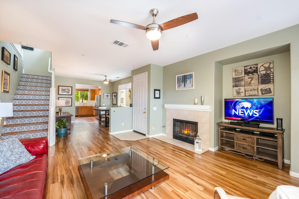 2307 Shakespeare Drive Oxnard, CA 93033 - Photo 8 of 42 a living room with furniture a fireplace and a flat screen tv