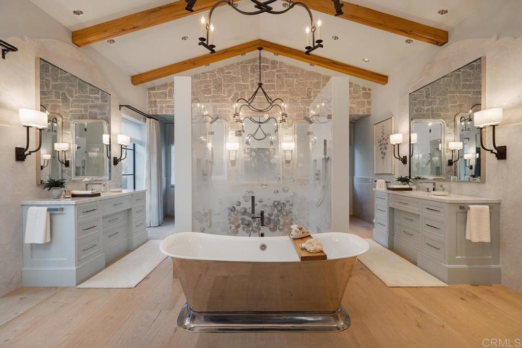 17845 Via De Fortuna Rancho Santa Fe, CA 92067 - Photo 19 of 45 a spacious bathroom with a double vanity sink a mirror and a bathtub