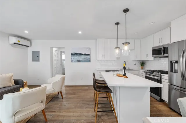 a kitchen with stainless steel appliances a refrigerator sink and white cabinets