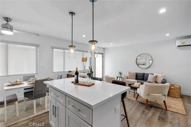a living room with furniture kitchen and a mirror