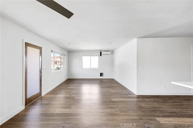 a view of room with window and wooden floor