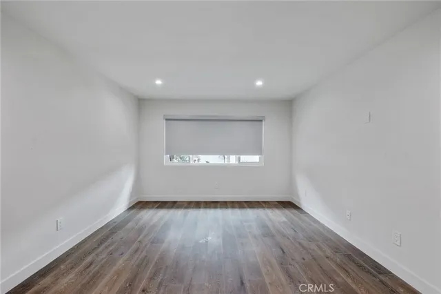 a kitchen with stainless steel appliances a refrigerator a sink a stove and white cabinets