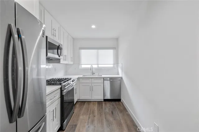 an empty room with a window and ceiling fan