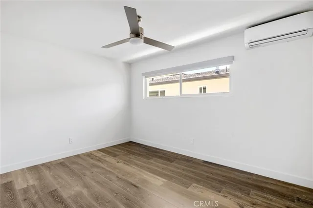 a bathroom with a granite countertop sink toilet a mirror and shower