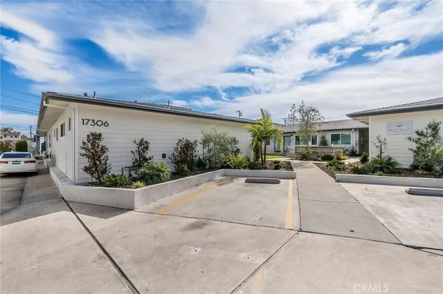 a view of a patio with couches table and chairs and potted plants