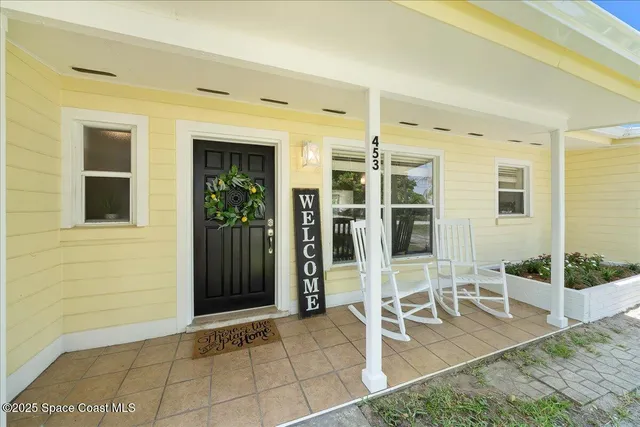 a view of an entryway with table and chair