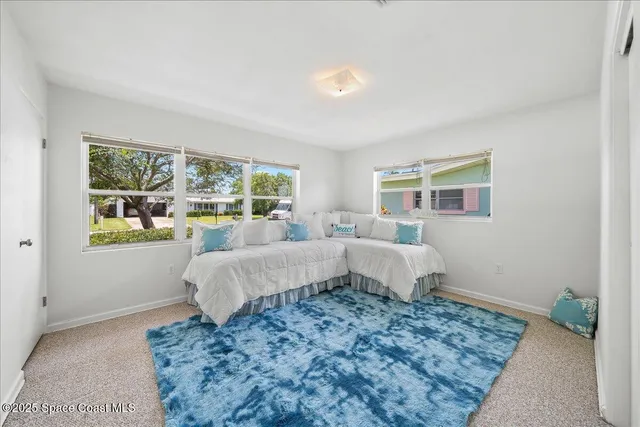 a bed room with a bed and a window