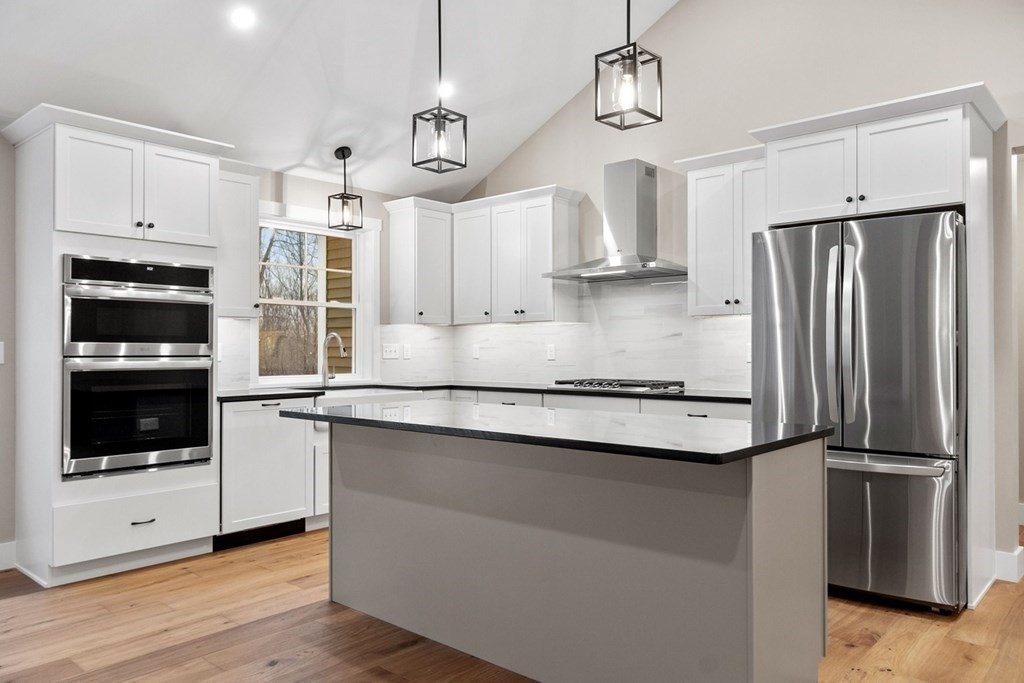 29 High Range Drive New Ipswich, NH 03071 - Photo 11 of 36 a kitchen with stainless steel appliances granite countertop a refrigerator and a stove top oven
