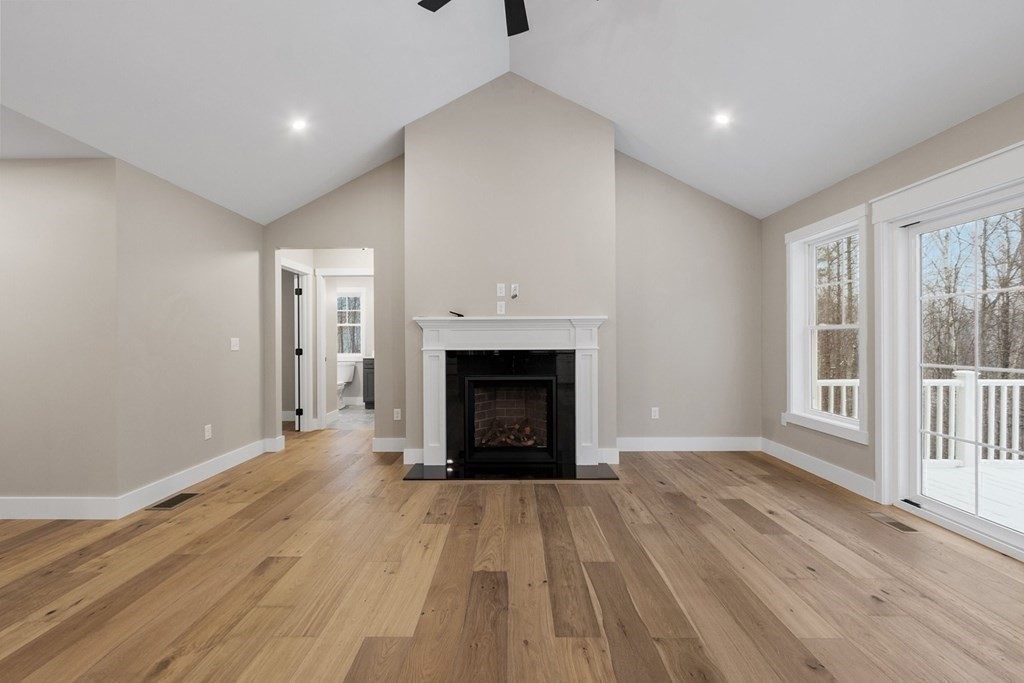 29 High Range Drive New Ipswich, NH 03071 - Photo 20 of 36 a view of an empty room with wooden floor fireplace and a window