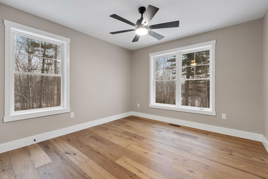 29 High Range Drive New Ipswich, NH 03071 - Photo 22 of 36 a view of an empty room with wooden floor and a window