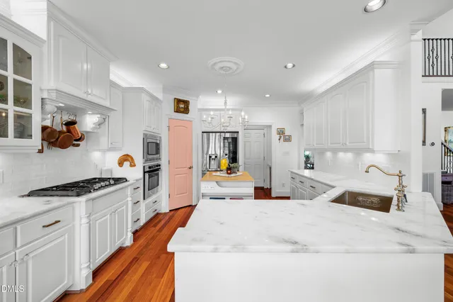 a bed room with a bed and a chandelier