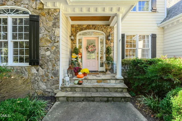 a dining room with wooden floor and a rug