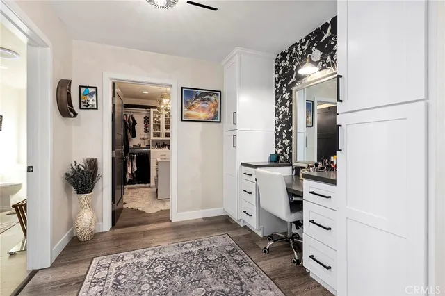 a view of a bedroom with workspace and window