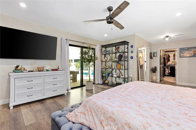 a bed room with a bed and a flat screen tv